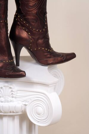 Leather female boots on a white podiumの写真素材
