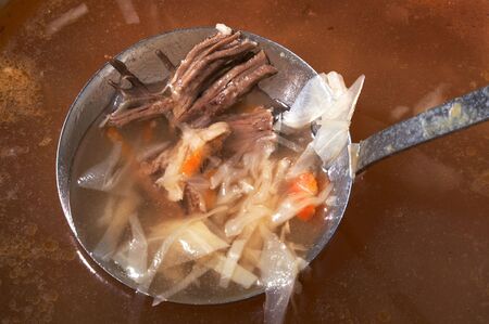 Ladle with meat in a saucepan with a russian cabbage soupの写真素材
