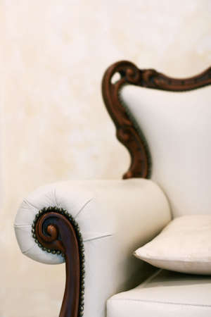 Beautiful white leather armchair with a pillowの写真素材