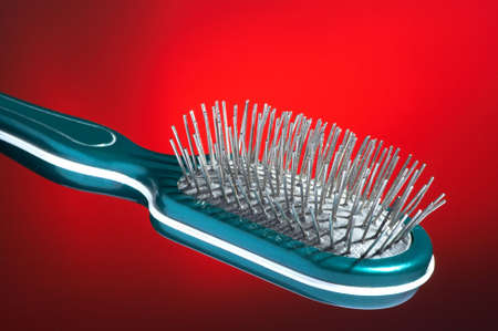 Hairbrush for hair on a dark red backgroundの写真素材