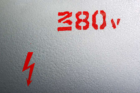 Bright red warning inscription about an electricityの写真素材