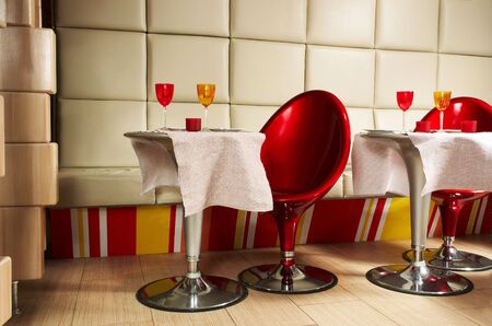 Beautiful red armchairs in modern youth cafeの写真素材