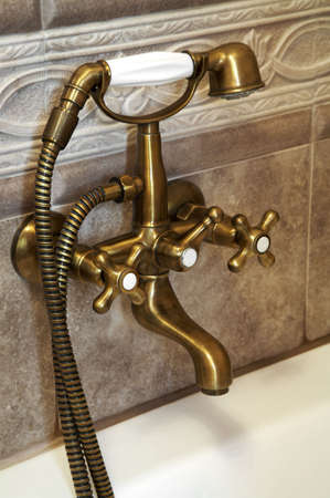 The beautiful bronze faucet in a bathroomの写真素材