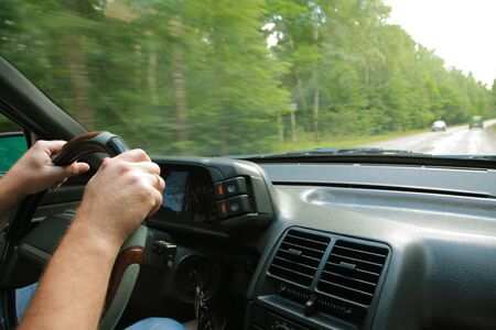 Trip on the car on wet asphalt road