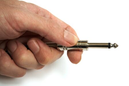 Hand holding a plug from a microphone