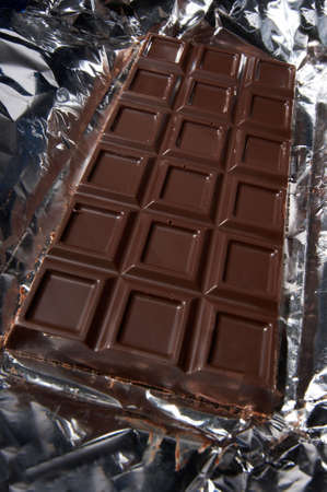 Tasty and sweet dark chocolate on a foil