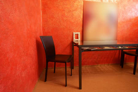 Chair and table on a background of a red wallの写真素材