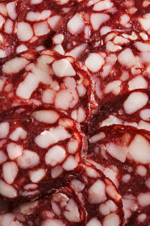Slices of smoked sausage as a backgroundの写真素材