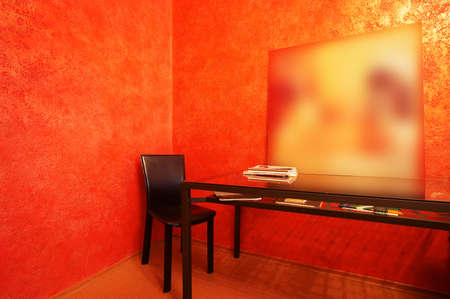 Chair and table on a background of a red wallの写真素材