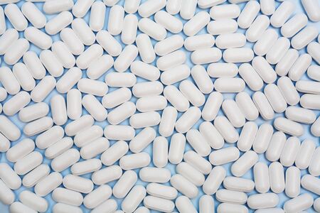 Many white pills as an abstract backgroundの写真素材
