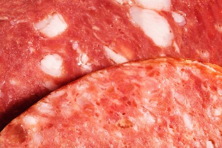 slices of sausage close up as a backgroundの写真素材