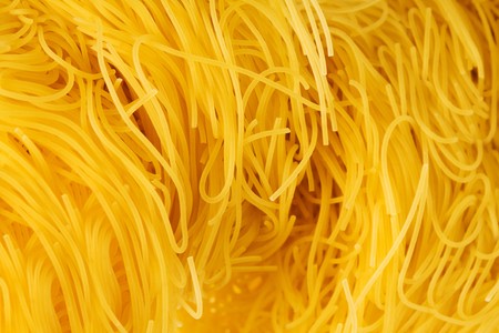 Yellow and beautiful pasta close-up as a backgroundの写真素材