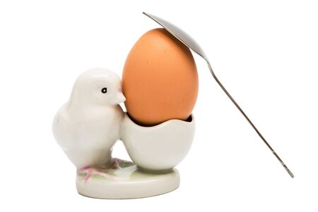 Egg and the spoon on a white background