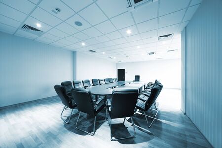 a large table and chairs in a modern conference roomの写真素材