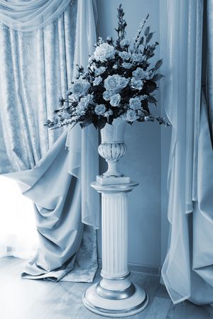 bouquet of beautiful flowers in the vase near the windowの写真素材