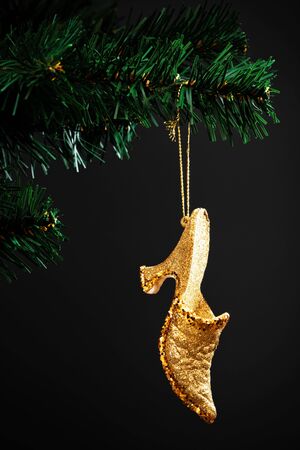 gold shoe on the artificial Christmas treeの写真素材