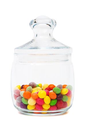 Candy in a glass jar on white backgroundの写真素材