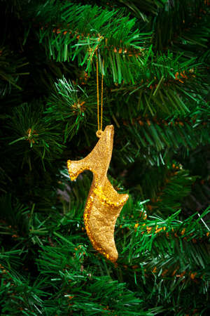 gold shoe on the artificial Christmas treeの写真素材