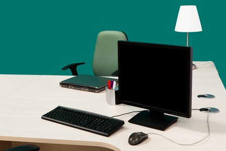 laptop and computer on a desk in a modern officeの写真素材