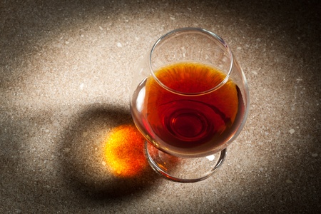 a glass of cognac on the marble table