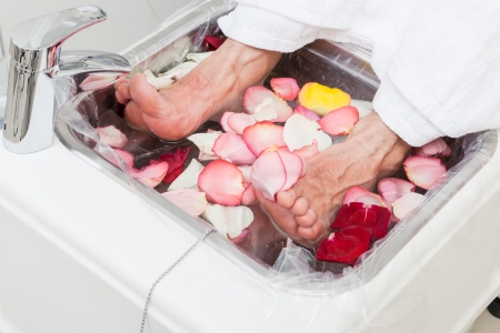 bath with rose leaf in pedicureの写真素材