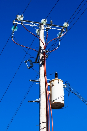 post with electrical wires in the skyの写真素材