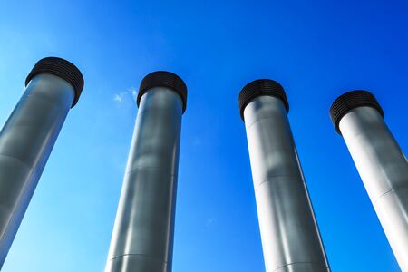 steel pipes against the blue skyの写真素材