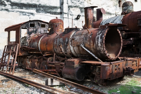 old rusty steam locomotive in background of the wall