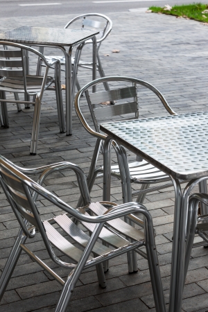tables and chairs in a cafe on the streetの写真素材