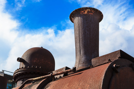 old steam locomotive pipe against the skyの写真素材