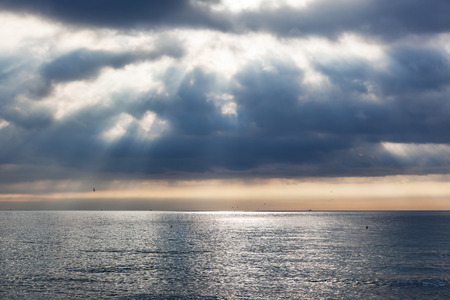 a sunrise over the calm oceanの写真素材