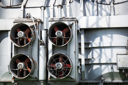 fans outdoors on a metal wall