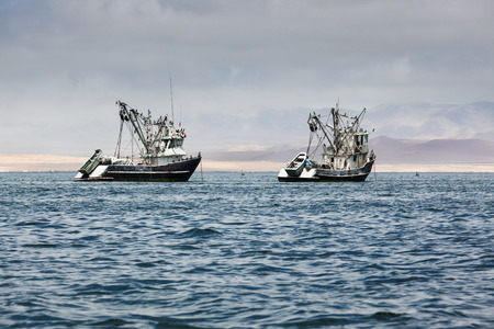 fishing boats in the bay of the Pacific Oceanの写真素材