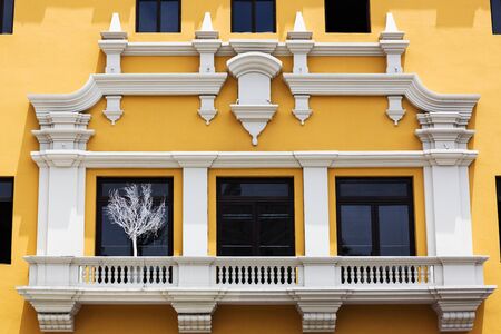 yellow house with a large balcony windowsの写真素材