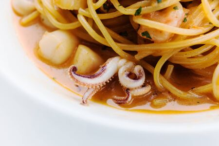 lunch with seafood on a white plateの写真素材