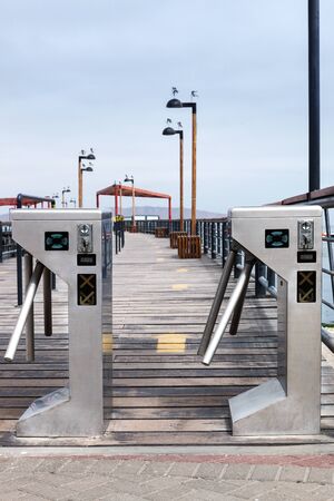 turnstile at the entrance to the pierの写真素材