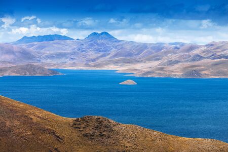 a small island in the mountain lakeの写真素材