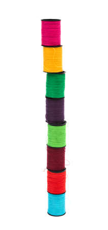 thread wound on spools on a white background