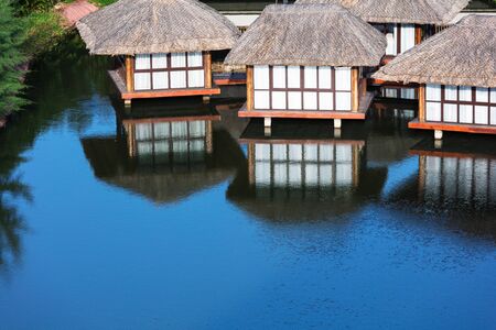 houses on stilts on a beautiful lakeの写真素材