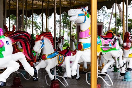 carousel. Horses on a carnival merry go roundの写真素材