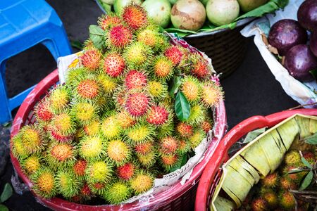 rambutan and other tropical exotic fruits on street marketの写真素材