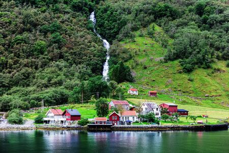 Reflection of a small town in norwegian fiord, Norwayの写真素材