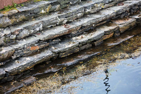 old steps out into the water