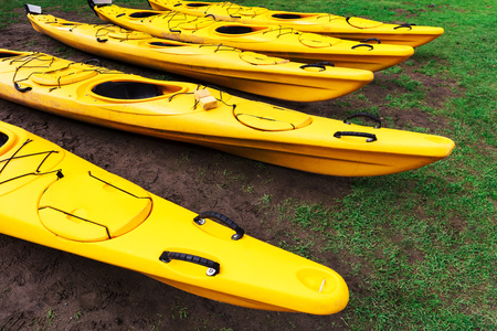 kayaks lie on the green lawnの写真素材