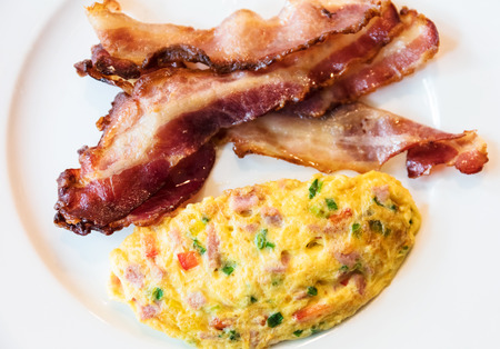 omelet with bacon served on white plate