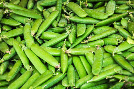 close-up green peas pods on retail displayの写真素材