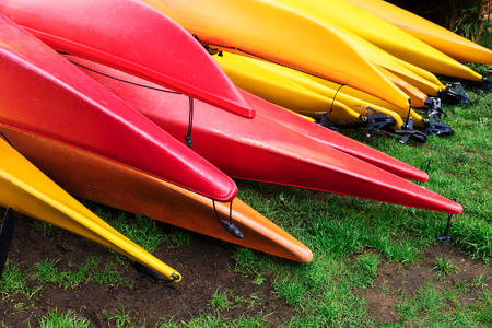 kayaks lie on the green lawnの写真素材