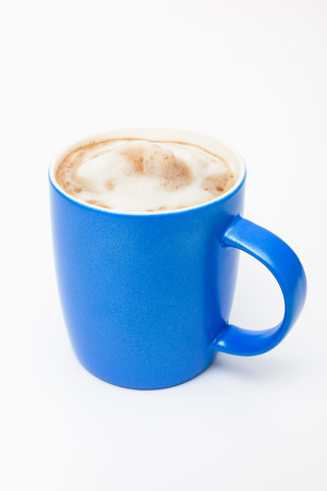 blue cup with a cappuccino on a white backgroundの写真素材