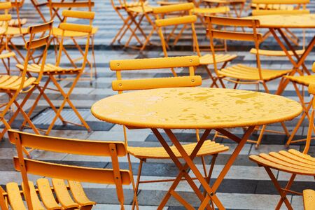 tables and chairs in a cafe on the streetの写真素材
