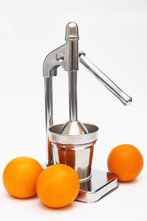 juicer with oranges on a white background
